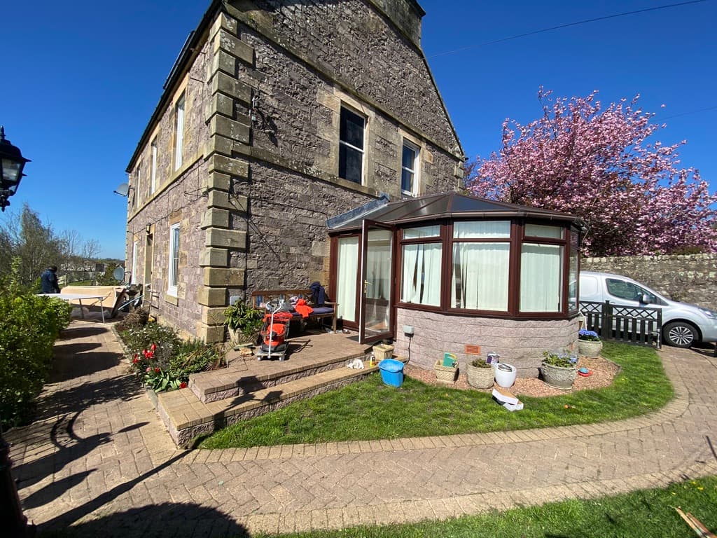 Beautifully restored stone property with pristine paving and tidy frontage