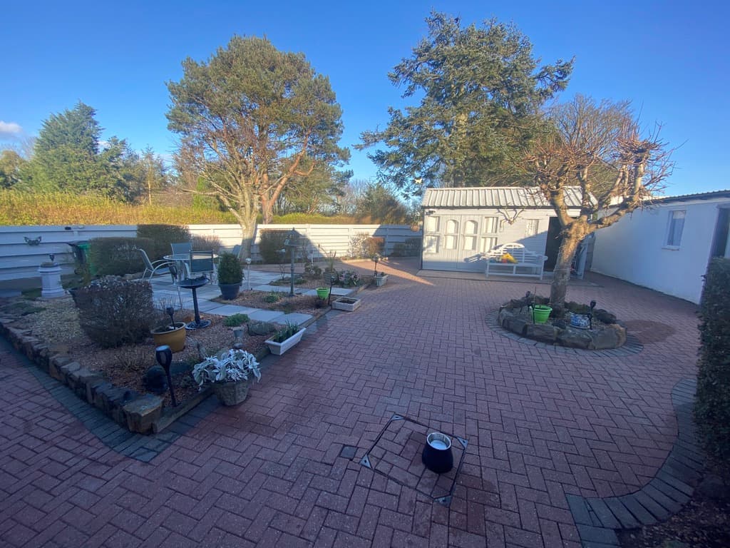 Pristine jet-washed paving surrounded by freshly painted fencing